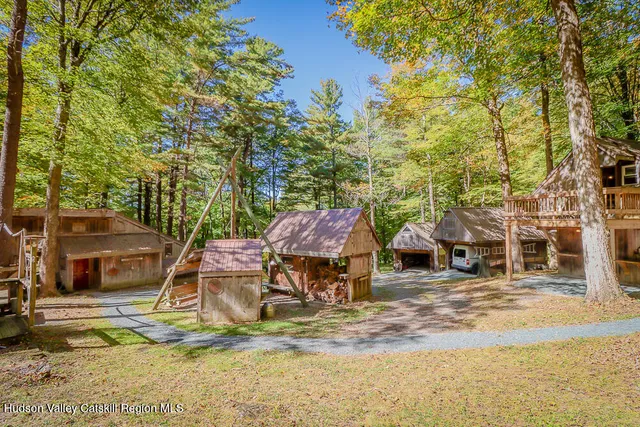 a view of a house with wooden stairs and a large tree