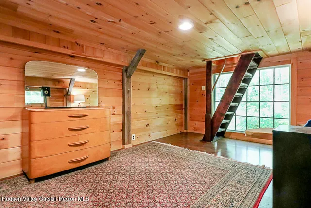 a bed sitting in a bedroom next to a window