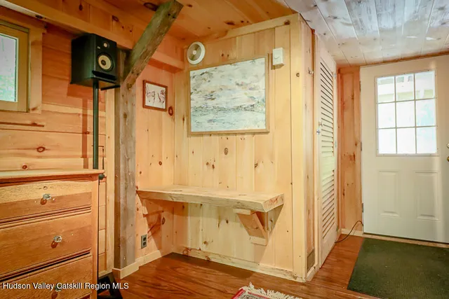 a view of a brick house with large windows and a tree