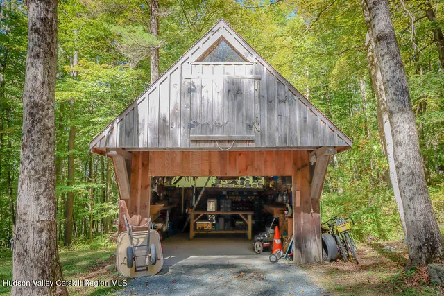 a backyard of a house with large trees and plants