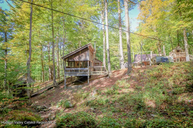 a view of a house with yard and sitting area