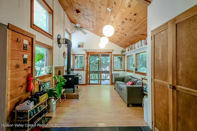 a living room with furniture floor to ceiling window and floor to ceiling window