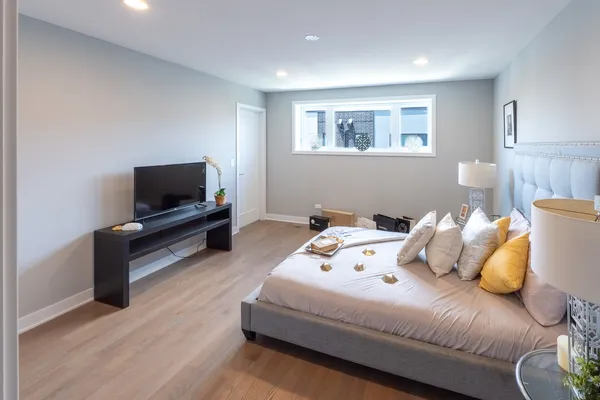 a bedroom with a bed and a tv
