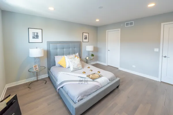 a bed room with a bed and a night stand