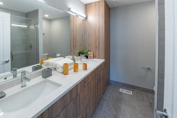a bathroom with a sink double vanity and a mirror