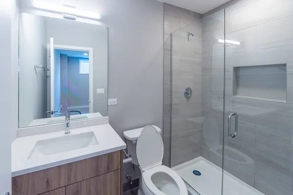 a bathroom with a sink toilet and shower