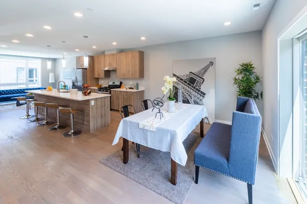 a living room with furniture a dining table and a potted plant