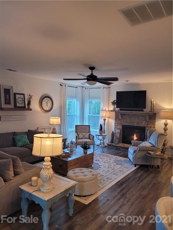 86581 Arrington Road Lancaster, SC 29720 - Photo 2 of 4 a living room with furniture a fireplace and a flat screen tv