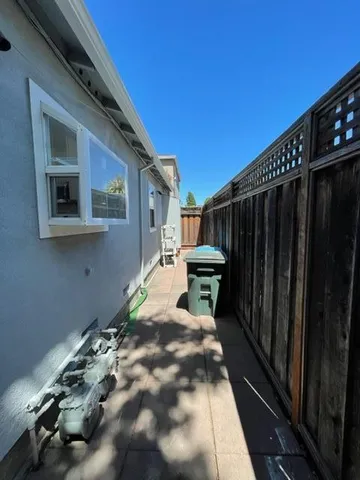 a backyard of a house with table and chairs