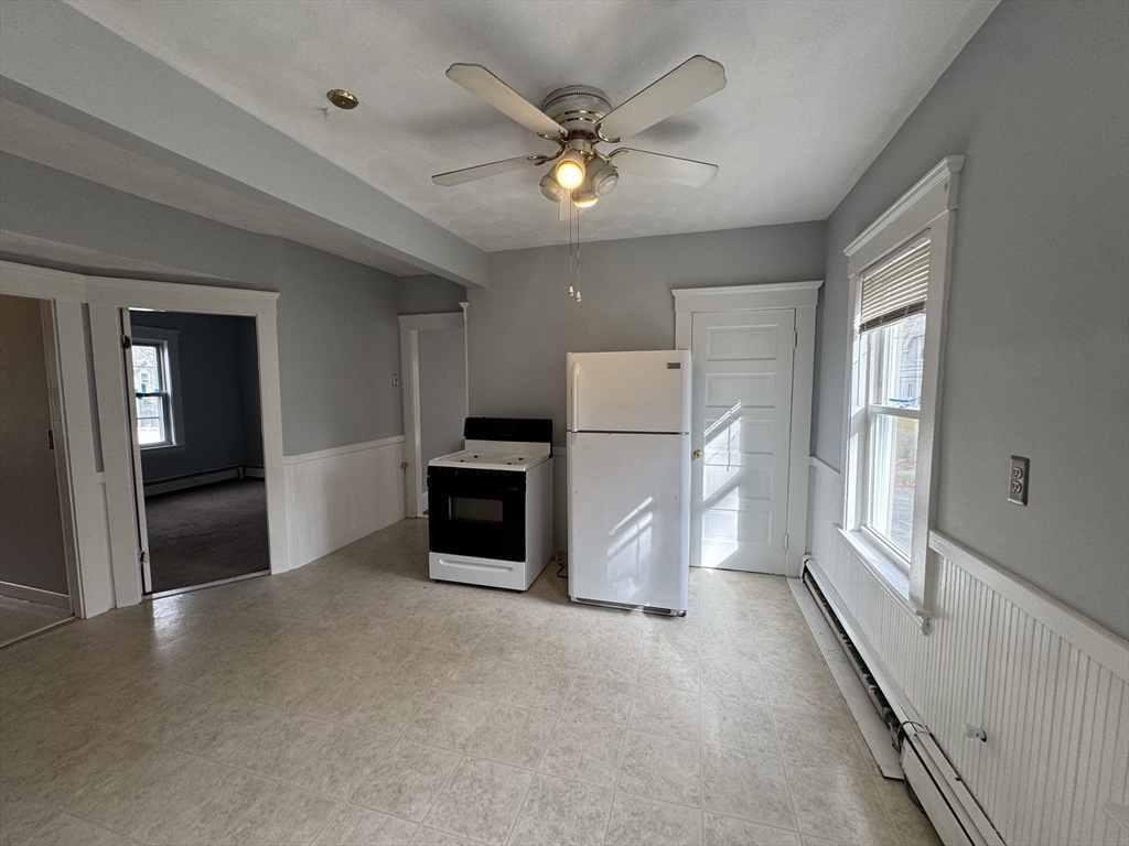 41 Thorndike Road, Unit 2 North Andover, MA 01845 - Photo 4 of 8 a view of a livingroom with a ceiling fan and refrigerator