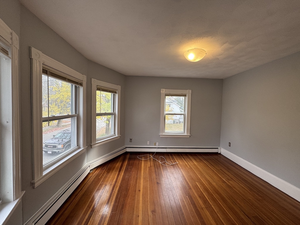 41 Thorndike Road, Unit 2 North Andover, MA 01845 - Photo 5 of 8 wooden floor in an empty room with a window