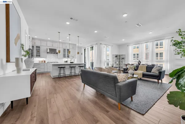 a living room with furniture and kitchen view