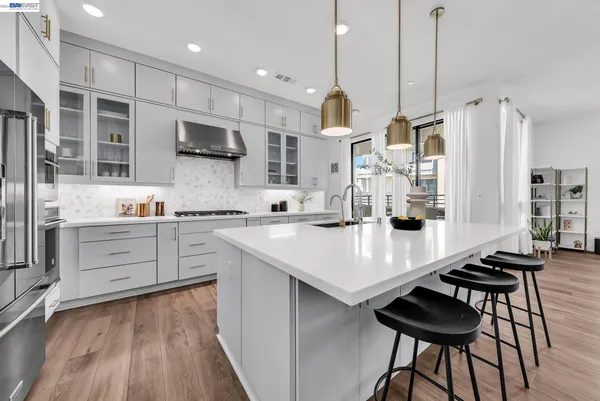 a kitchen with a sink stove and cabinets