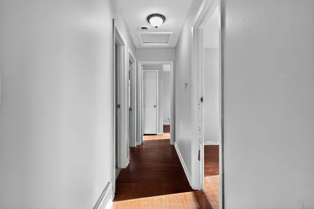 a view of a hallway with a dining room