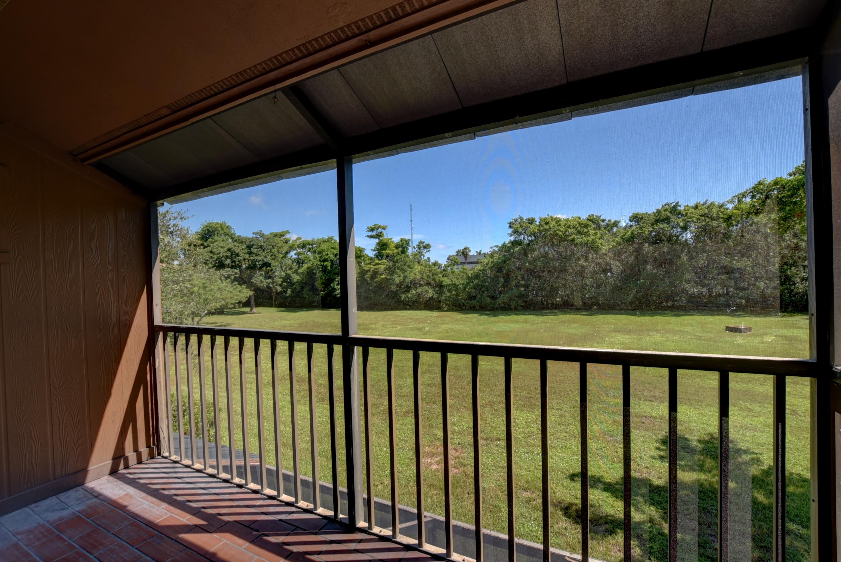2525 Southwest 22nd Avenue, Unit 202 Delray Beach, FL 33445 - Photo 7 of 32 Patio and view of grass field