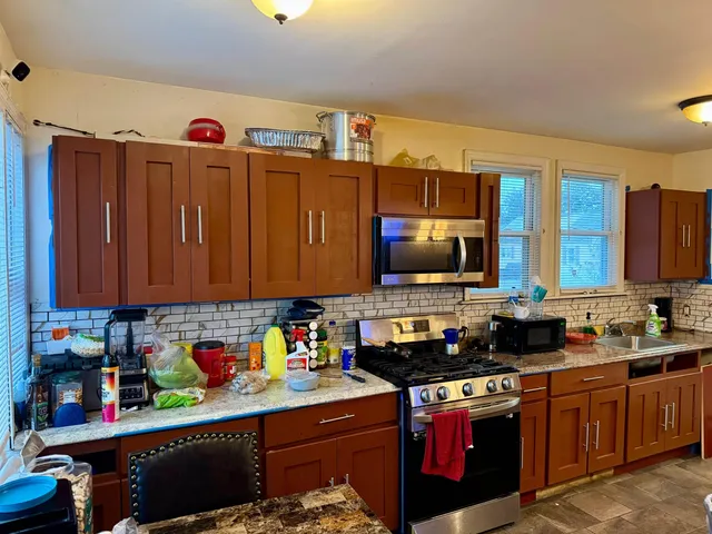 a kitchen with lots of appliances and cabinets