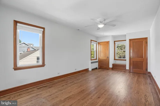 a bedroom with a large bed couch and a window