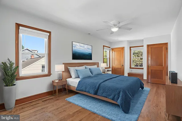 an empty room with a window and wooden floor