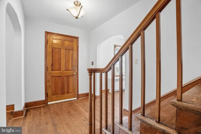 a view of an entryway with wooden floor and stairs