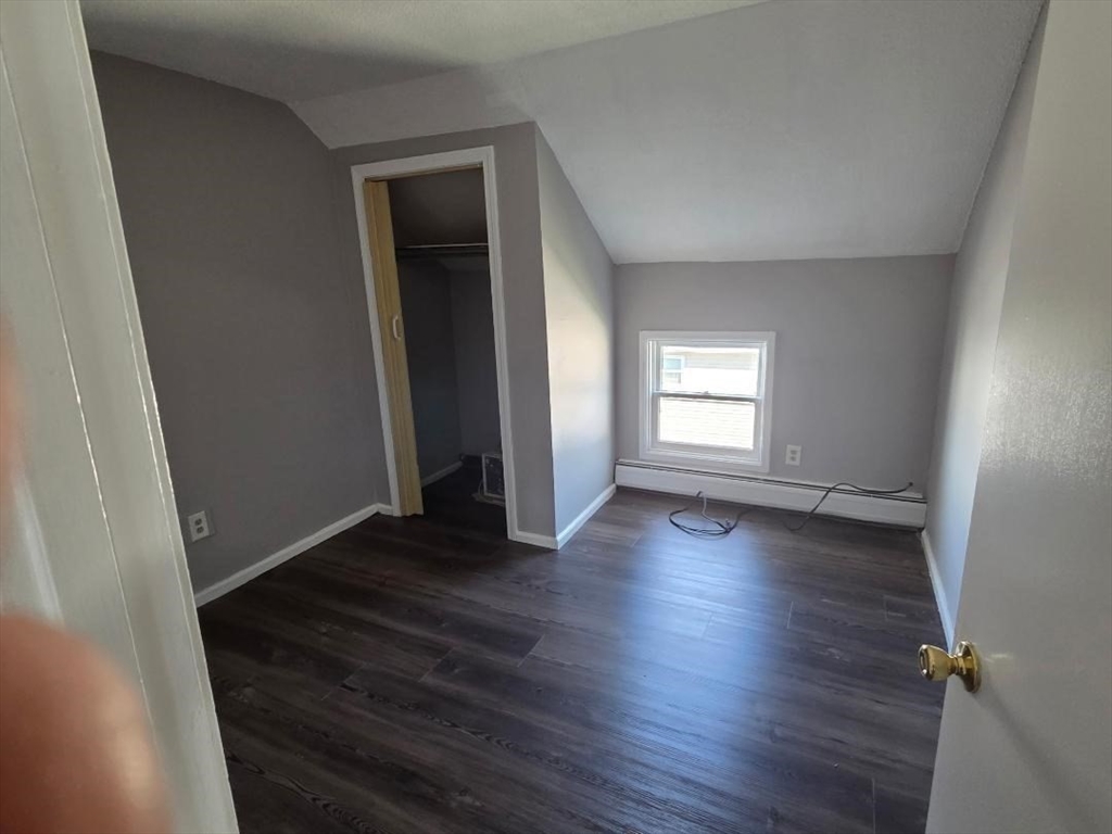 14 Carver Street, Unit 3 Fall River, MA 02721 - Photo 8 of 8 an empty room with wooden floor and windows