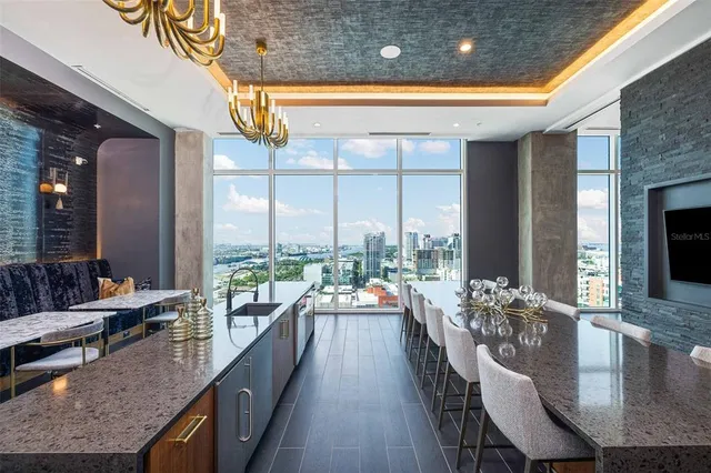 a living room with patio furniture and a flat screen tv