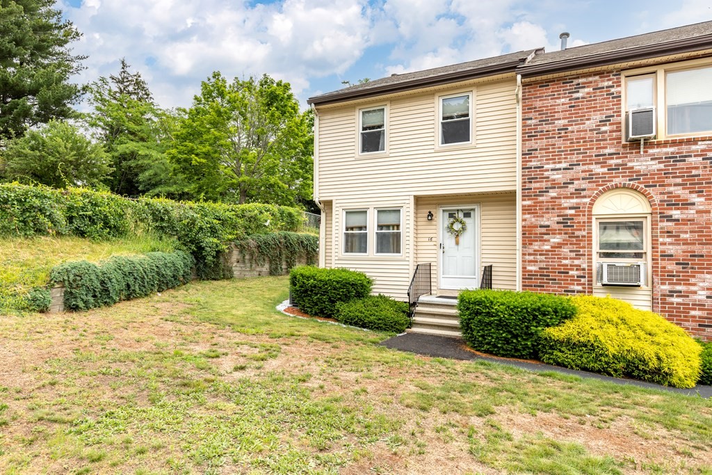 3 Woodland Street, Unit 16 Lawrence, MA 01841 - Photo 1 of 29 a front view of a house with a yard and garage