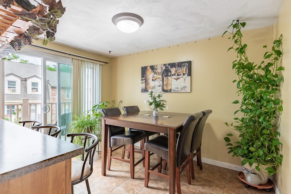 3 Woodland Street, Unit 16 Lawrence, MA 01841 - Photo 13 of 29 a view of a dining room with furniture window and wooden floor