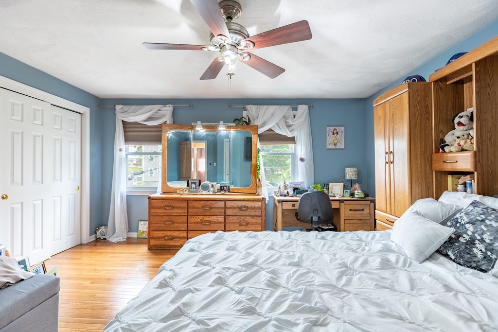 3 Woodland Street, Unit 16 Lawrence, MA 01841 - Photo 19 of 29 a bedroom with a large bed and a chandelier