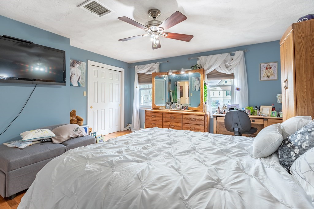 3 Woodland Street, Unit 16 Lawrence, MA 01841 - Photo 20 of 29 a bedroom with a large bed and a chandelier
