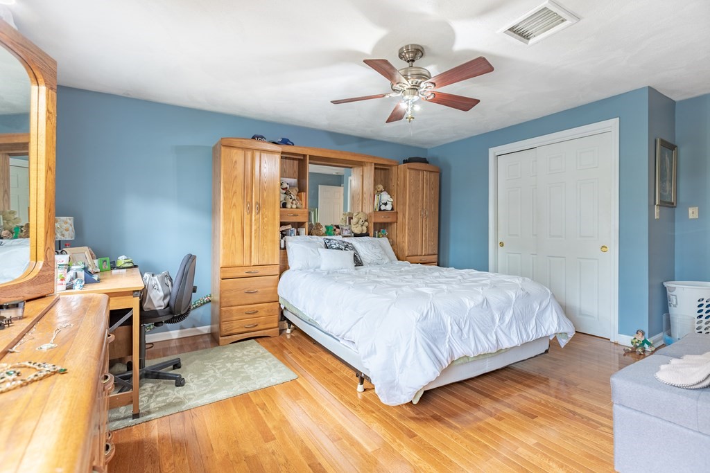 3 Woodland Street, Unit 16 Lawrence, MA 01841 - Photo 21 of 29 a bedroom with a bed and wooden floor
