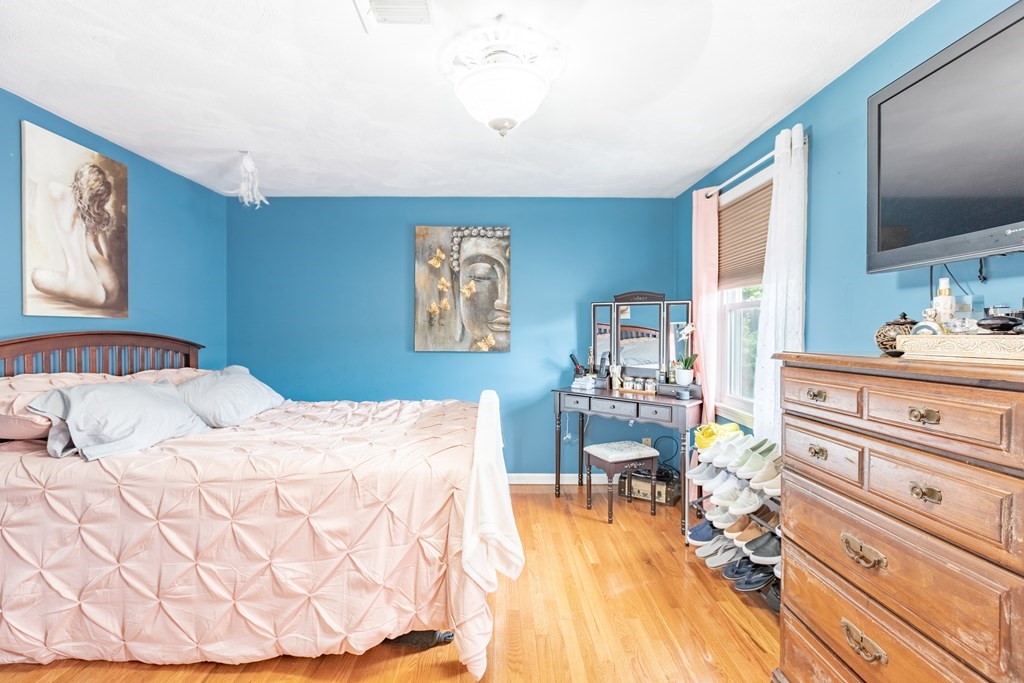 3 Woodland Street, Unit 16 Lawrence, MA 01841 - Photo 23 of 29 a bedroom with a bed and a flat screen tv