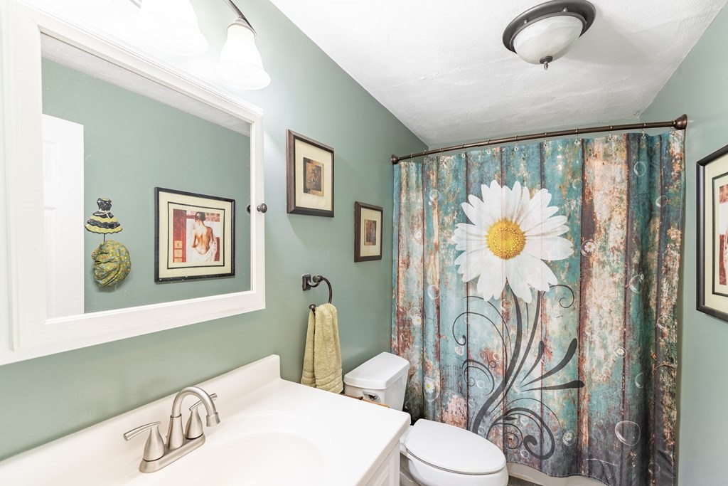 3 Woodland Street, Unit 16 Lawrence, MA 01841 - Photo 24 of 29 a bathroom with a toilet sink and mirror