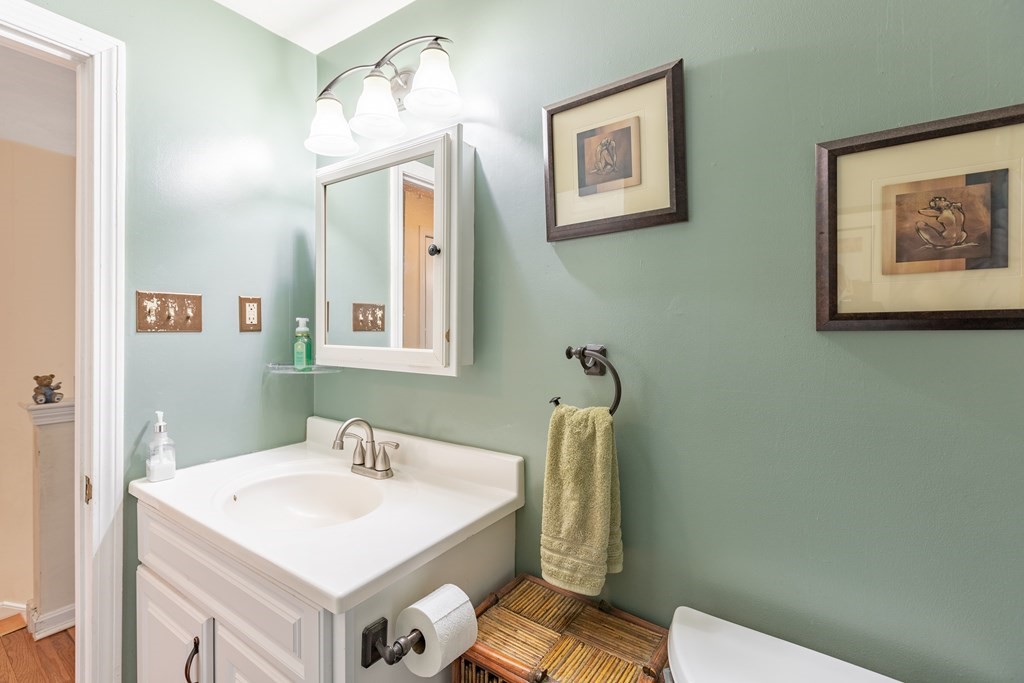 3 Woodland Street, Unit 16 Lawrence, MA 01841 - Photo 25 of 29 a bathroom with a sink mirror vanity and toilet