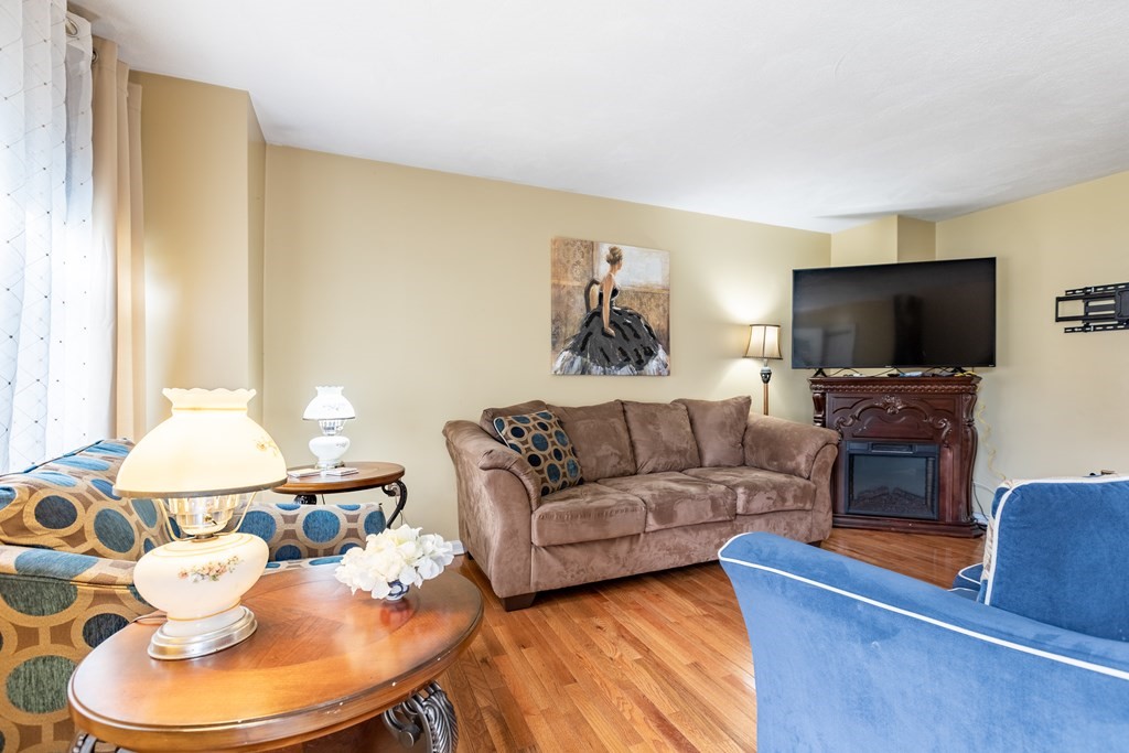 3 Woodland Street, Unit 16 Lawrence, MA 01841 - Photo 3 of 29 a living room with furniture and a flat screen tv