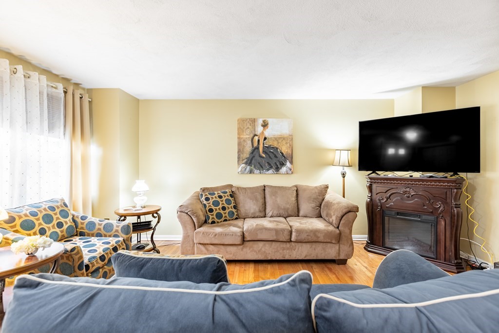3 Woodland Street, Unit 16 Lawrence, MA 01841 - Photo 6 of 29 a living room with furniture and a flat screen tv