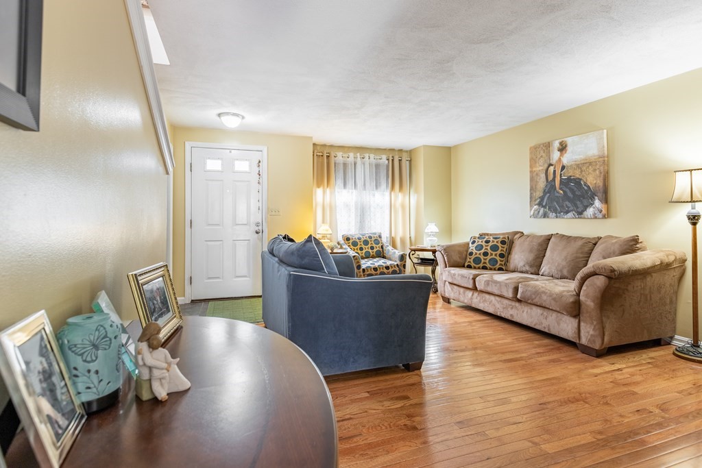 3 Woodland Street, Unit 16 Lawrence, MA 01841 - Photo 9 of 29 a living room with furniture and a wooden floor