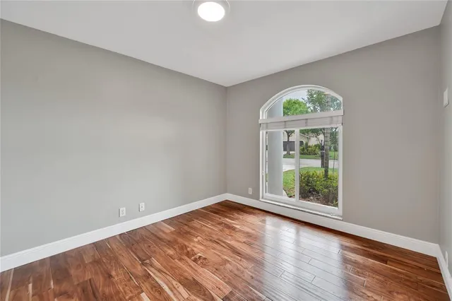 a view of an empty room with wooden floor