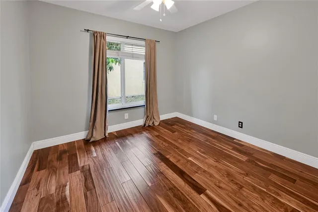 a view of room with wooden floor