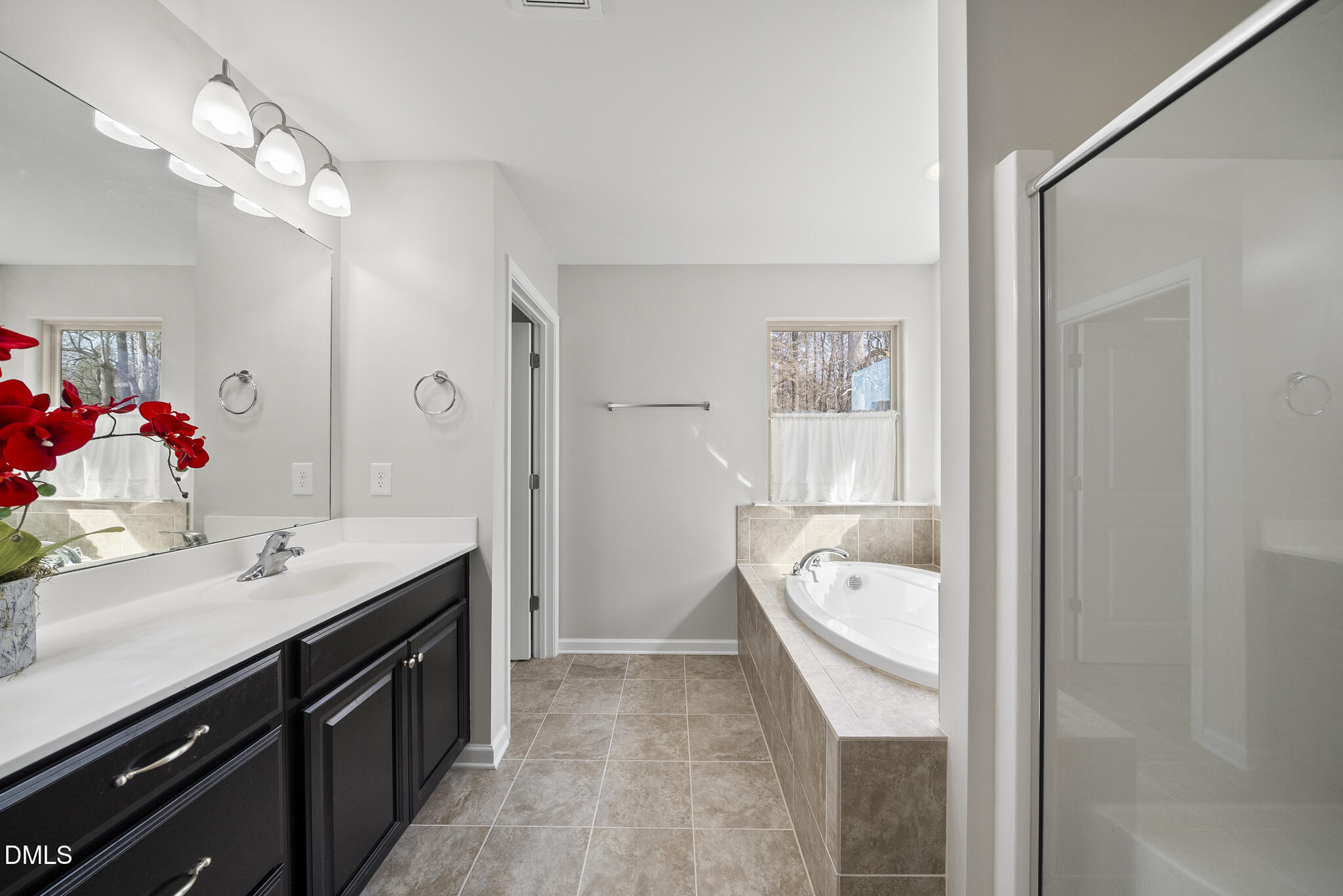 332 Forbes Road Wake Forest, NC 27587 - Photo 18 of 32 a bathroom with a tub sink and mirror