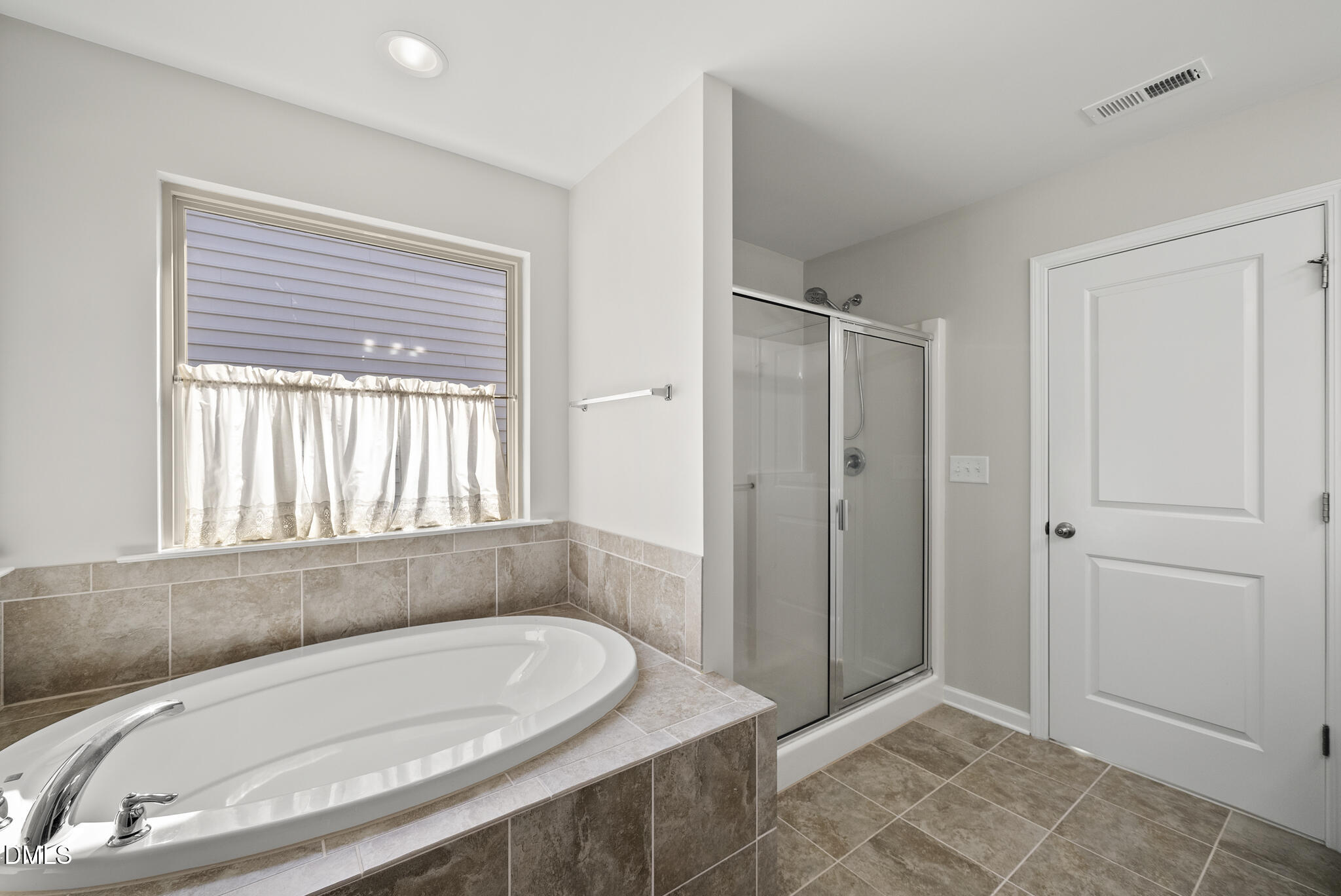 332 Forbes Road Wake Forest, NC 27587 - Photo 20 of 32 a bathroom with a tub and a window