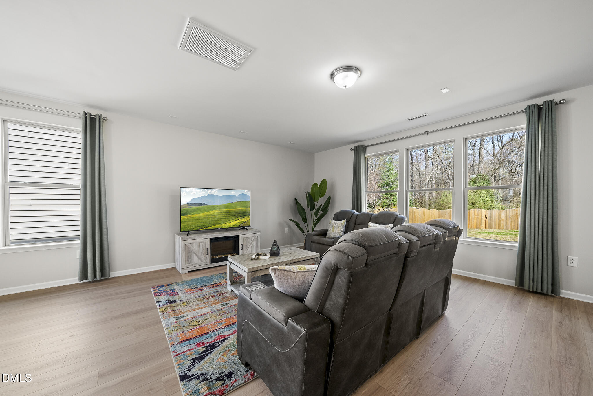 332 Forbes Road Wake Forest, NC 27587 - Photo 7 of 32 a living room with furniture a window and a flat screen tv