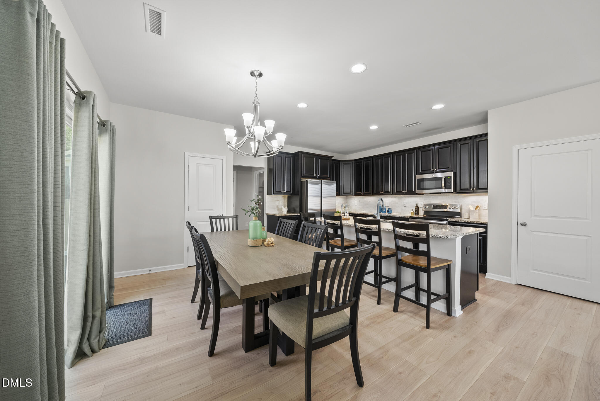 332 Forbes Road Wake Forest, NC 27587 - Photo 8 of 32 a view of a dining room with furniture and chandelier