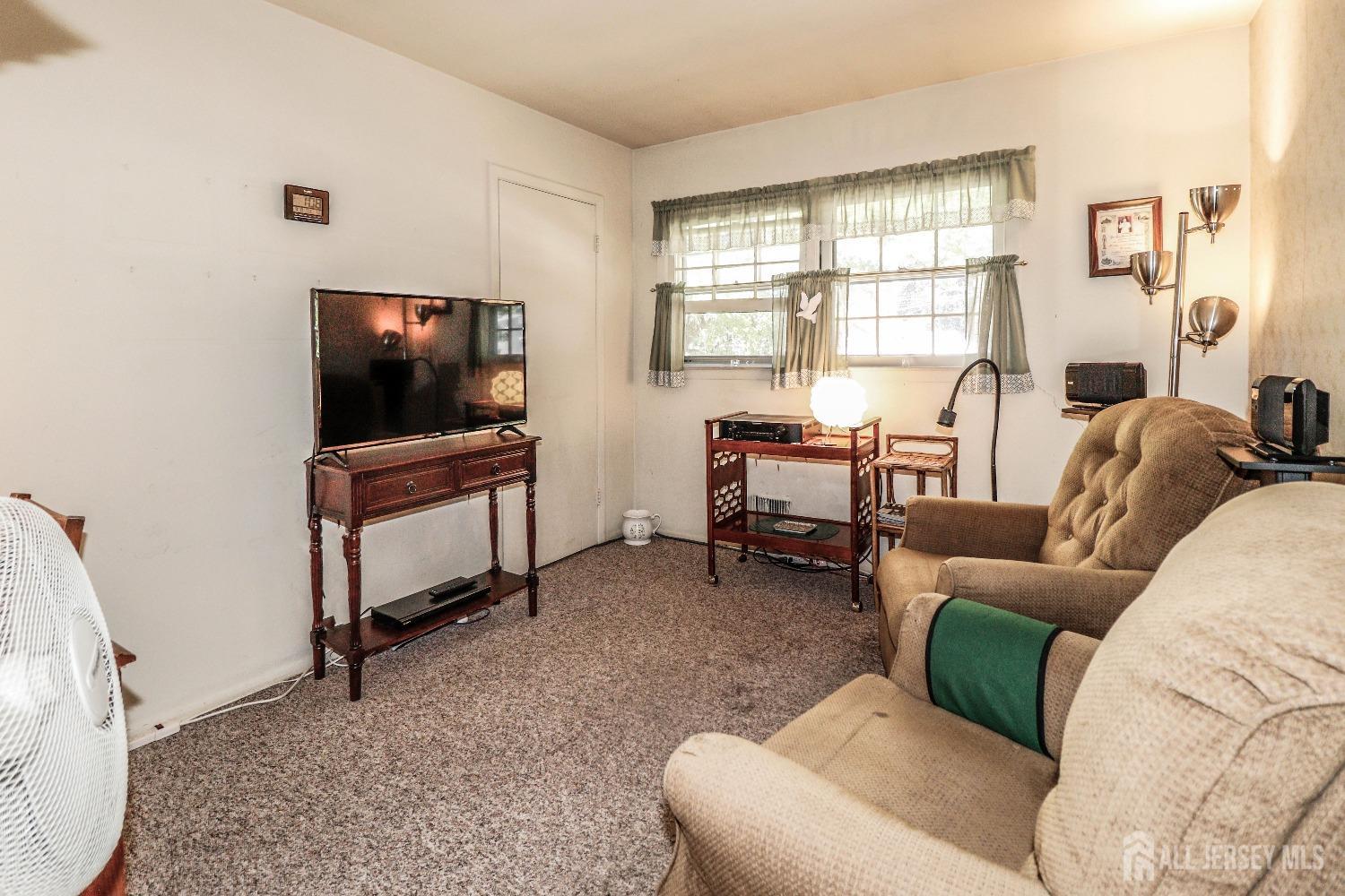 33 Harmon Road Edison, NJ 08837 - Photo 14 of 25 a living room with furniture and a flat screen tv