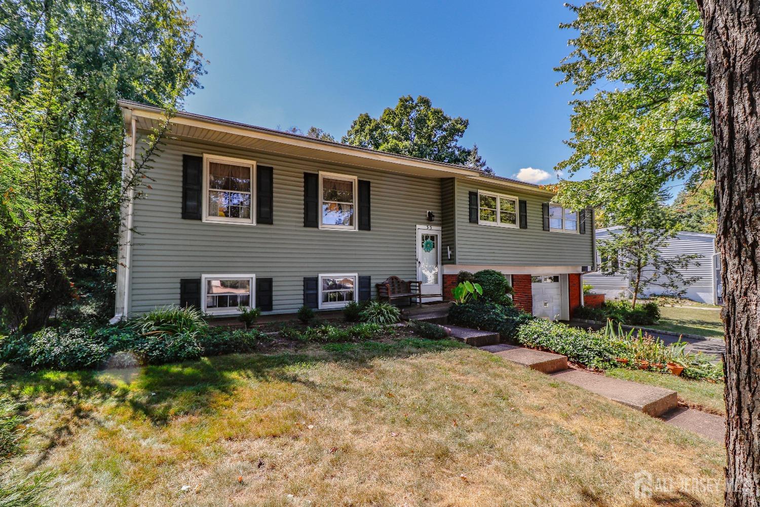 33 Harmon Road Edison, NJ 08837 - Photo 3 of 25 a house that has a tree in front of it