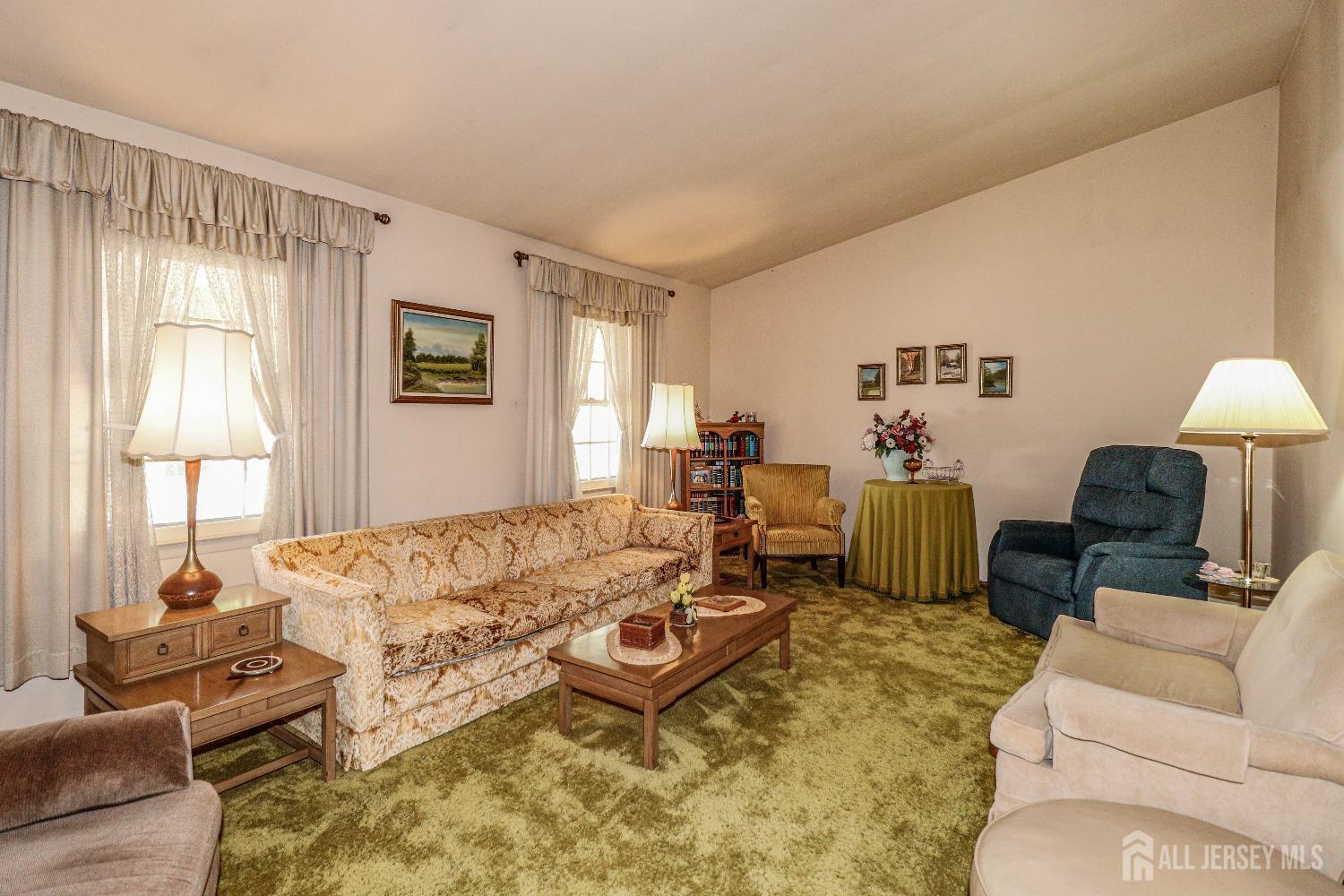 33 Harmon Road Edison, NJ 08837 - Photo 5 of 25 a living room with furniture a lamp and a table