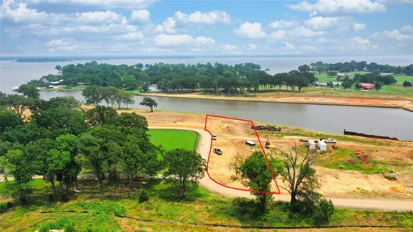 a view of a lake with houses in the back