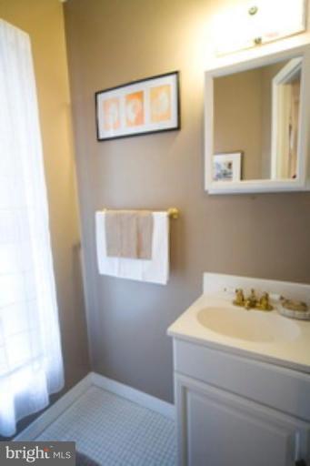 6512 Darwin Road Laurel, MD 20707 - Photo 11 of 22 a bathroom with a sink and a window