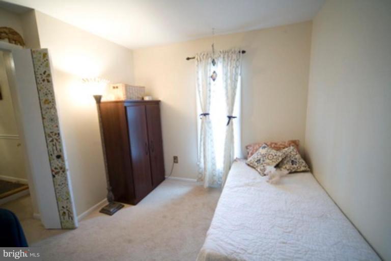 6512 Darwin Road Laurel, MD 20707 - Photo 12 of 22 a bedroom with a bed and a mirror
