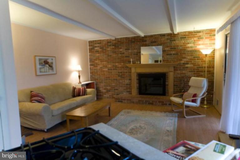 6512 Darwin Road Laurel, MD 20707 - Photo 4 of 22 a living room with furniture and a fireplace