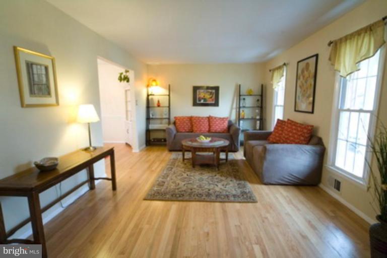 6512 Darwin Road Laurel, MD 20707 - Photo 7 of 22 a living room with furniture and a rug
